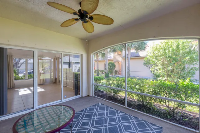 an aerial view of a house with a yard and trees