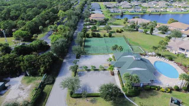 an aerial view of a house with garden space and lake view