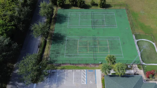 an aerial view of a house with swimming pool and garden view