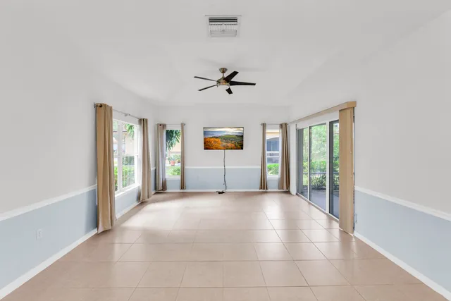 a view of a livingroom with an empty space and a ceiling fan