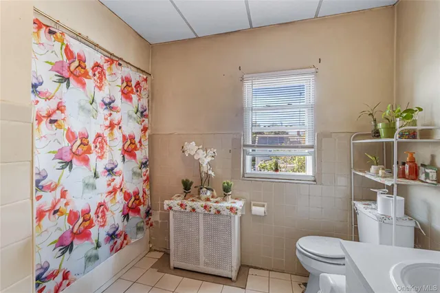 a bathroom with a sink mirror vanity and toilet