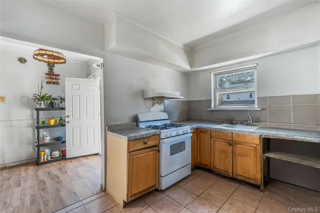 a kitchen with stainless steel appliances granite countertop a sink and a stove