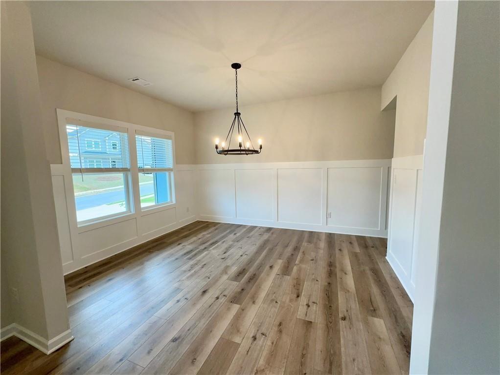345 Rodeo Drive Auburn, GA 30011 - Photo 4 of 22 wooden floor in an empty room with a window