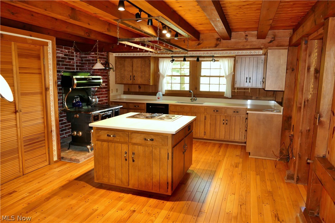 17340 Huntley Road Huntsburg, OH 44046 - Photo 10 of 24 Kitchen with sink, beamed ceiling, wooden ceiling, and light wood-type flooring
