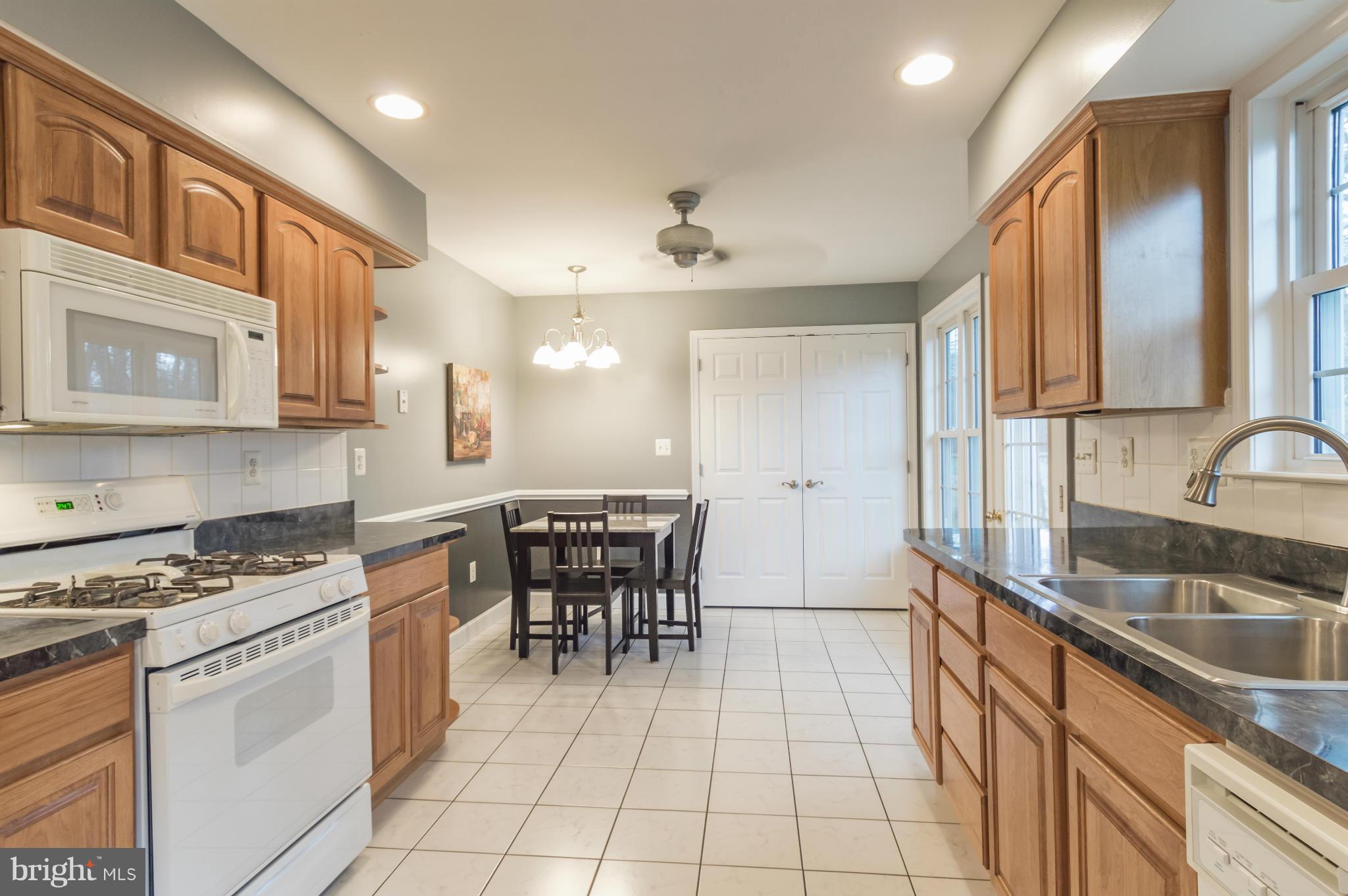 5912 Hillside Road St. Leonard, MD 20685 - Photo 10 of 30 Lots of cabinets and counter space. Door to deck.
