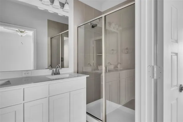 a bathroom with a granite countertop sink mirror and double