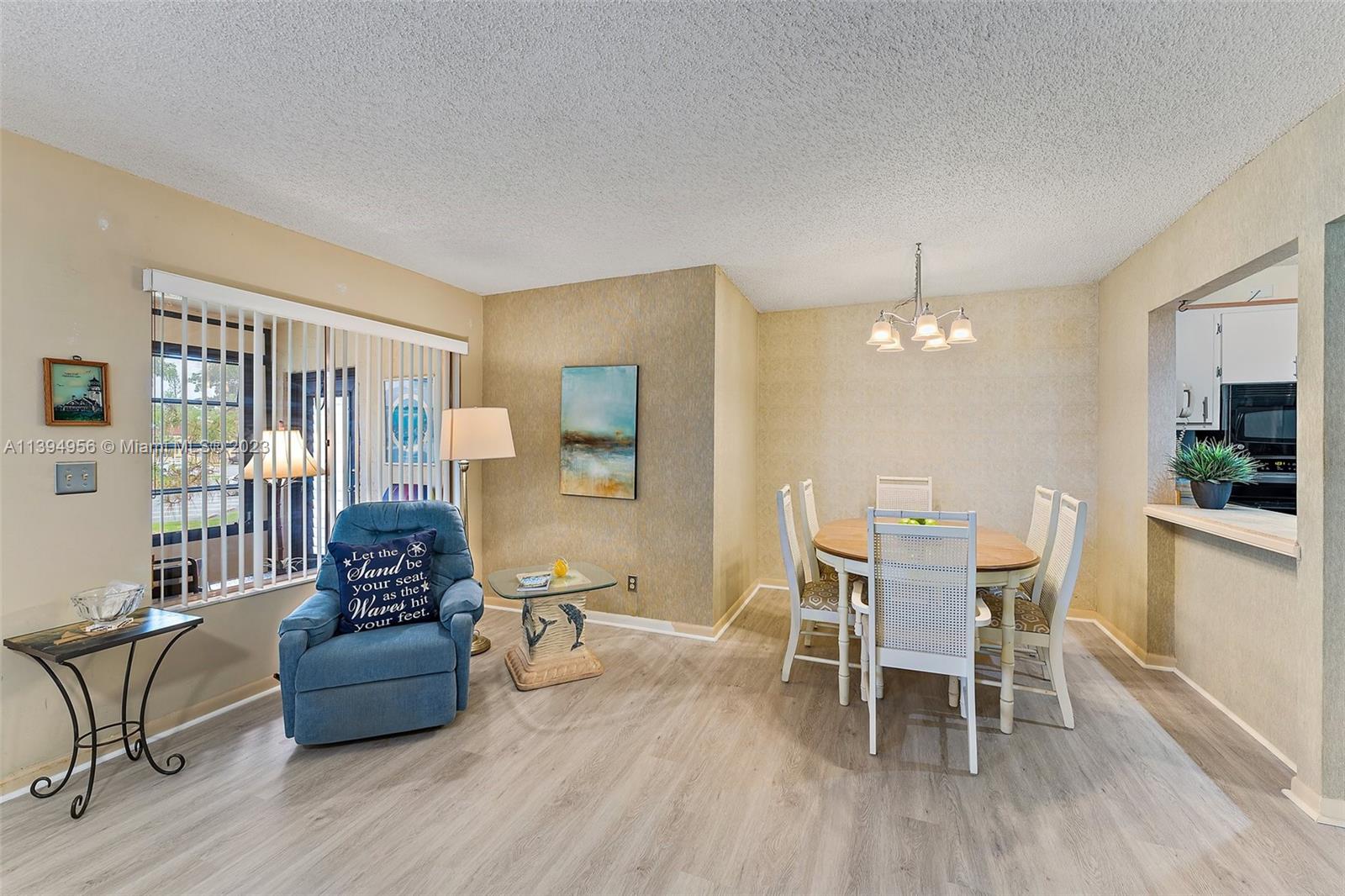 307 Pine Ridge Circle, Unit D2 Greenacres, FL 33463 - Photo 11 of 41 a living room with furniture and a wooden floor