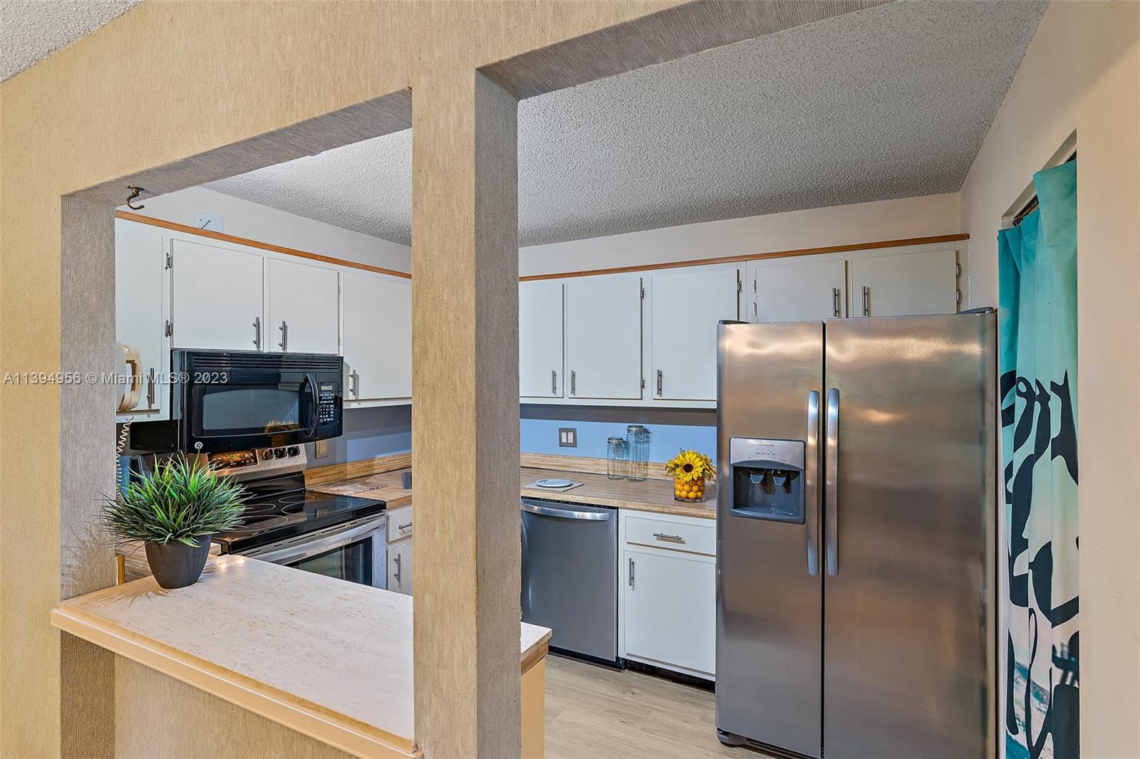 307 Pine Ridge Circle, Unit D2 Greenacres, FL 33463 - Photo 13 of 41 a kitchen with a refrigerator and a stove top oven