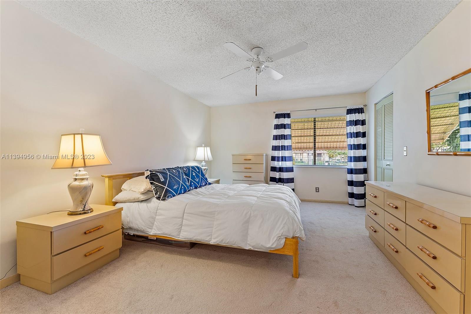 307 Pine Ridge Circle, Unit D2 Greenacres, FL 33463 - Photo 18 of 41 a bedroom with a bed and a dresser