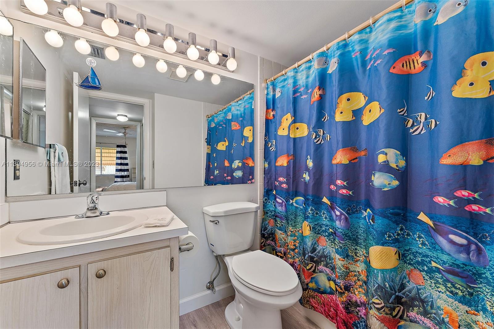 307 Pine Ridge Circle, Unit D2 Greenacres, FL 33463 - Photo 23 of 41 a bathroom with a sink mirror vanity and toilet