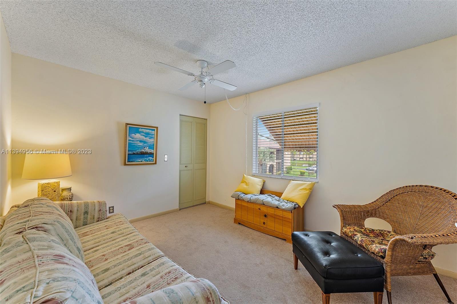307 Pine Ridge Circle, Unit D2 Greenacres, FL 33463 - Photo 24 of 41 a bedroom with bed couch and window
