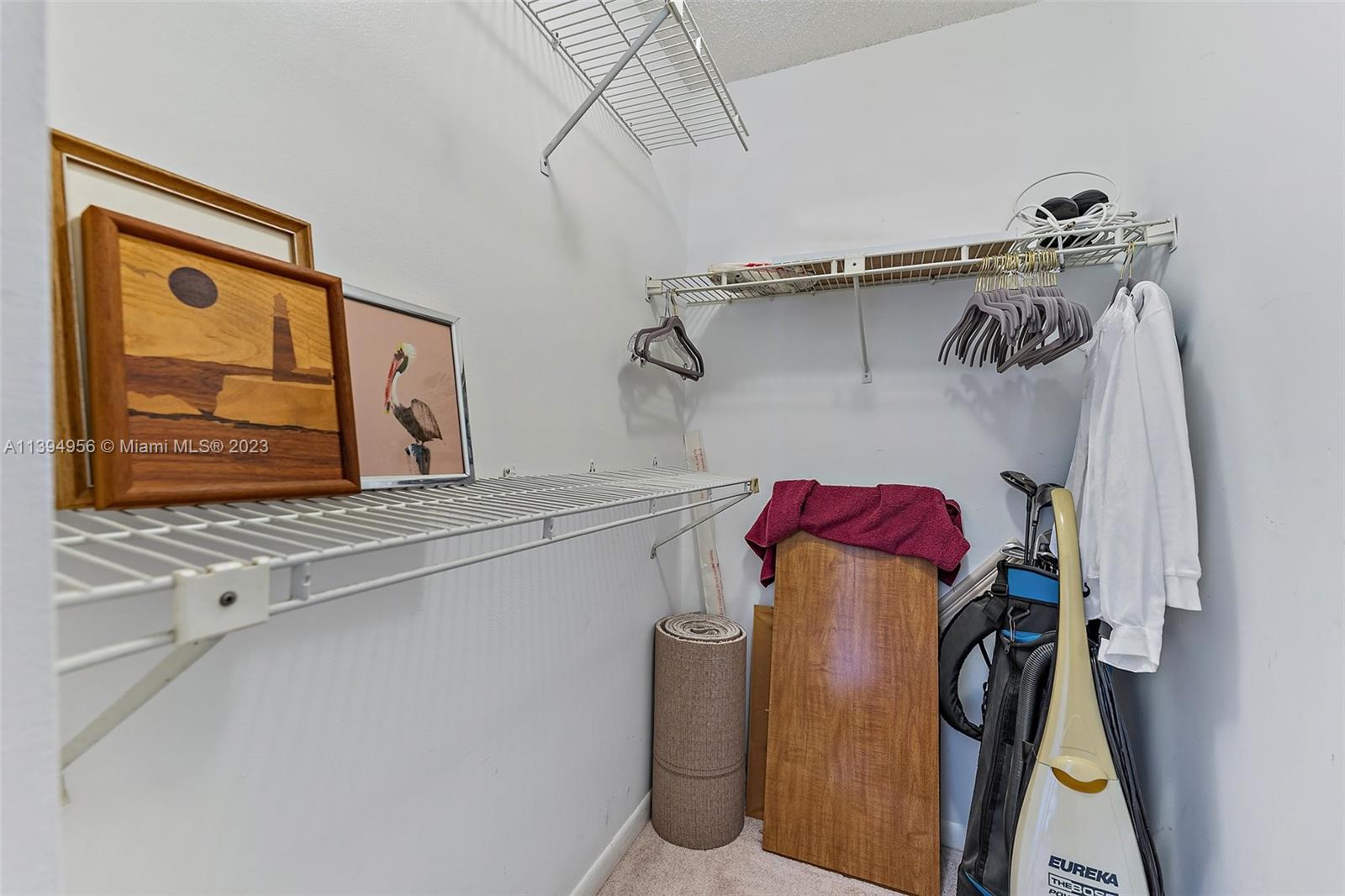 307 Pine Ridge Circle, Unit D2 Greenacres, FL 33463 - Photo 26 of 41 a view of walk in closet with clothes and shoes