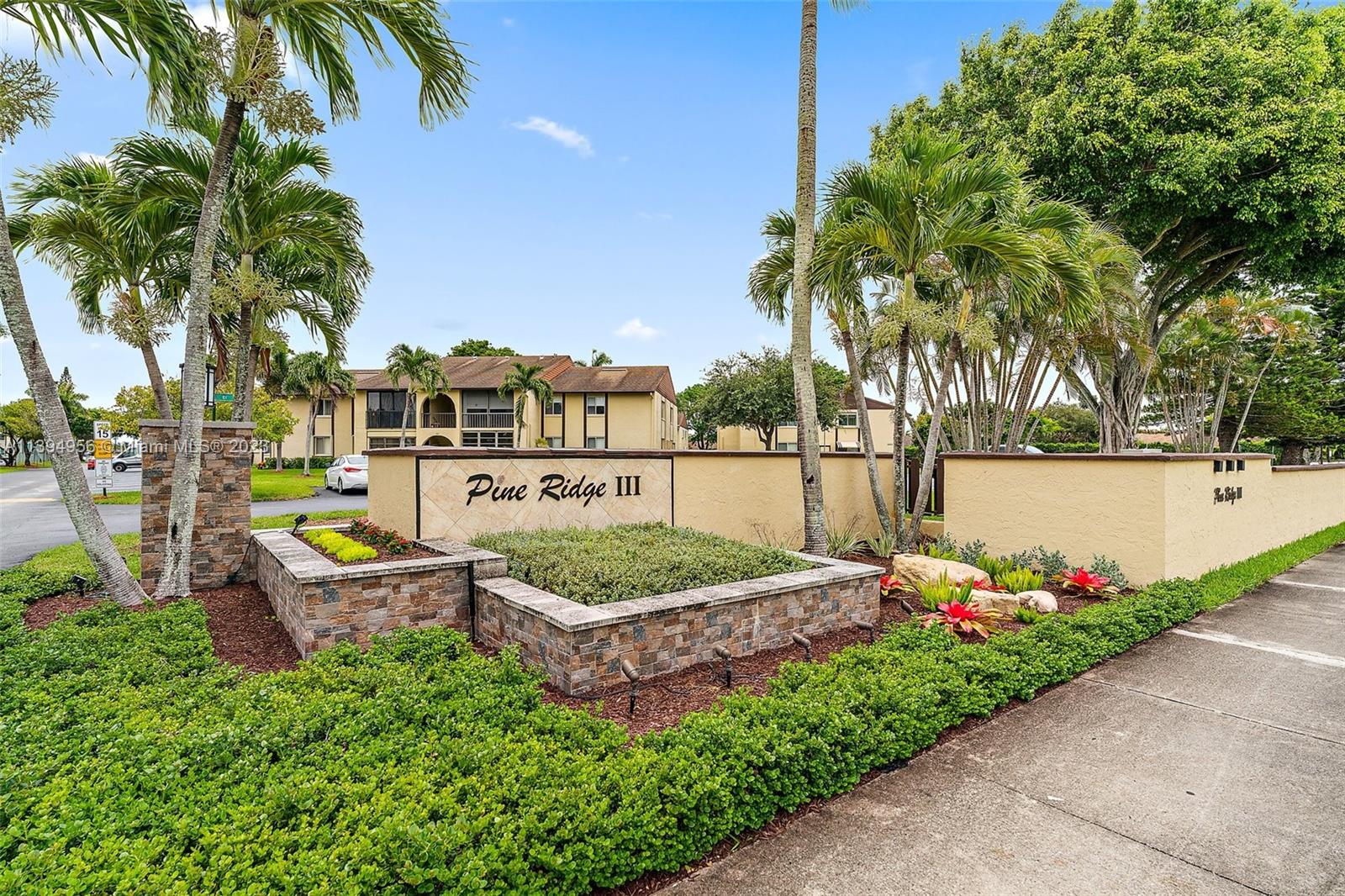 307 Pine Ridge Circle, Unit D2 Greenacres, FL 33463 - Photo 41 of 41 a garden view with a seating space