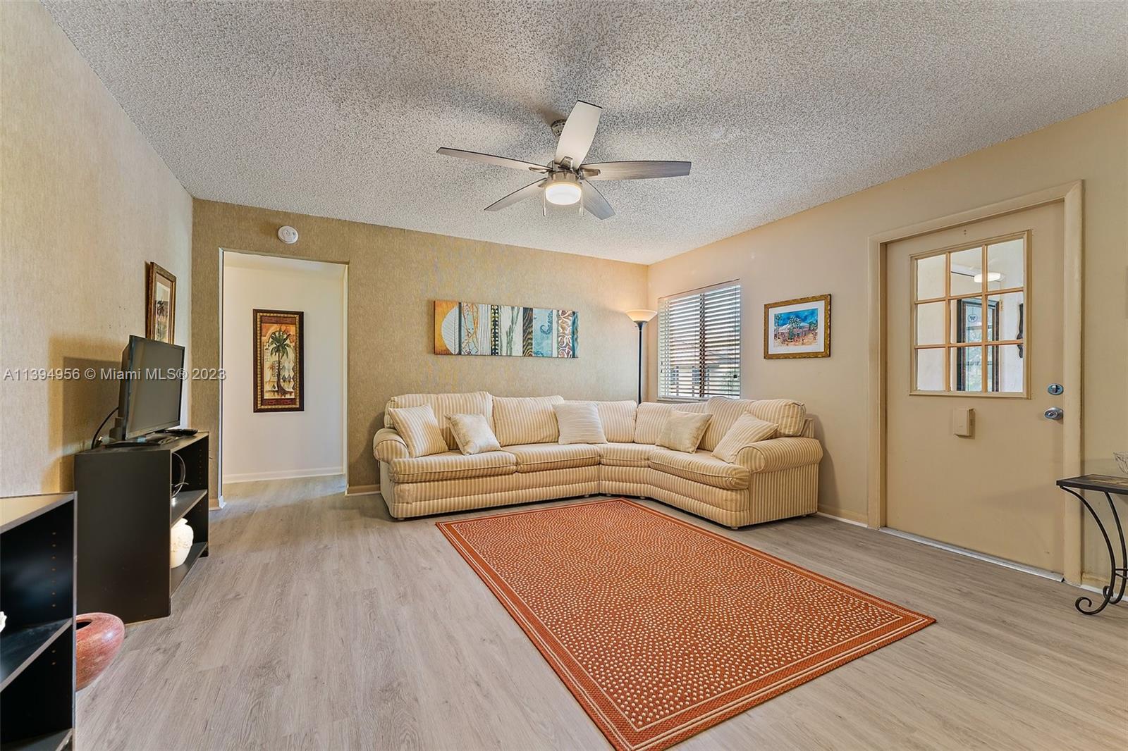 307 Pine Ridge Circle, Unit D2 Greenacres, FL 33463 - Photo 7 of 41 a living room with furniture and a flat screen tv