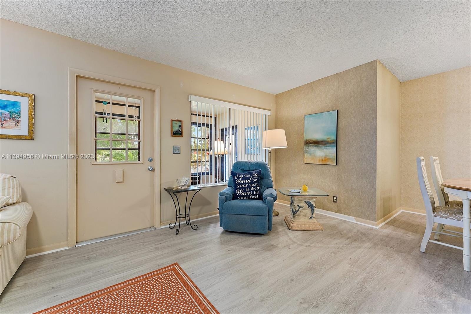307 Pine Ridge Circle, Unit D2 Greenacres, FL 33463 - Photo 8 of 41 a living room with furniture and a wooden floor