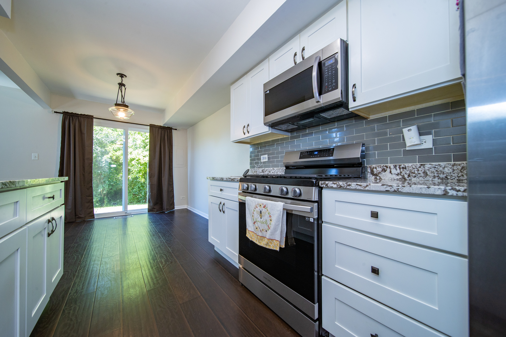 228 Butternut Lane Streamwood, IL 60107 - Photo 4 of 15 a kitchen with stainless steel appliances granite countertop a stove and a microwave