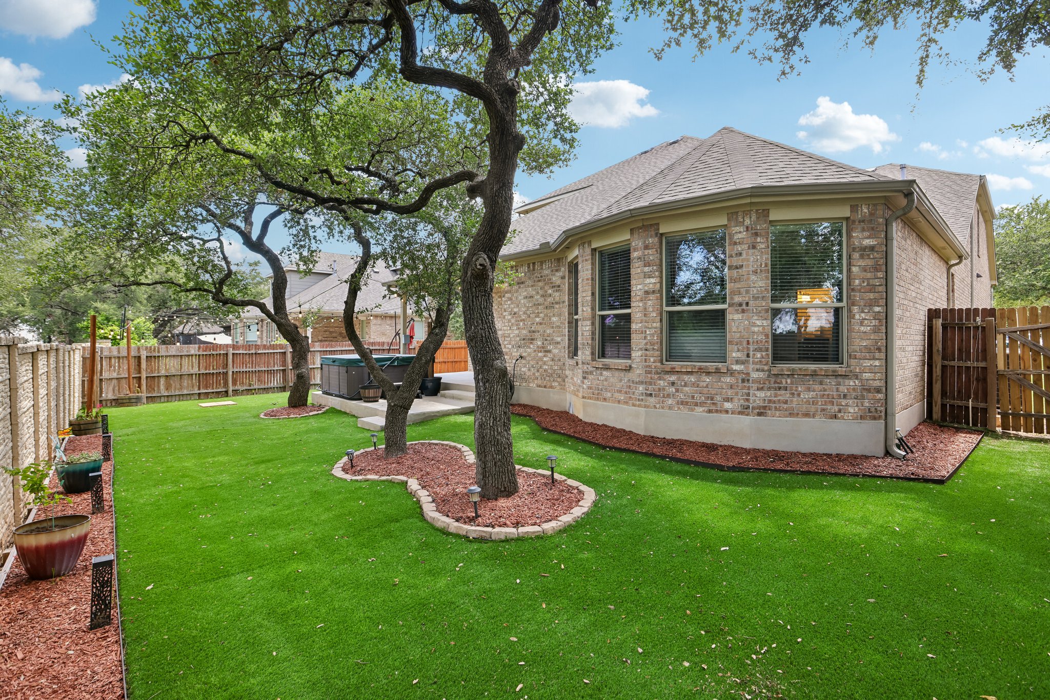 1924 Granite Springs Road Leander, TX 78641 - Photo 35 of 36 A private, fenced yard with lush green turf and mature trees, perfect for outdoor enjoyment.