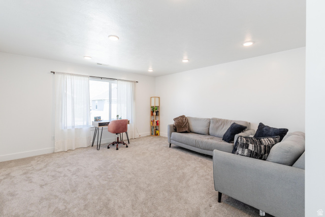 349 West 3085 South Logan, UT 84321 - Photo 22 of 37 Spacious room featuring neutral carpeting, white walls, recessed ceiling lights, and a large window with sheer white curtains