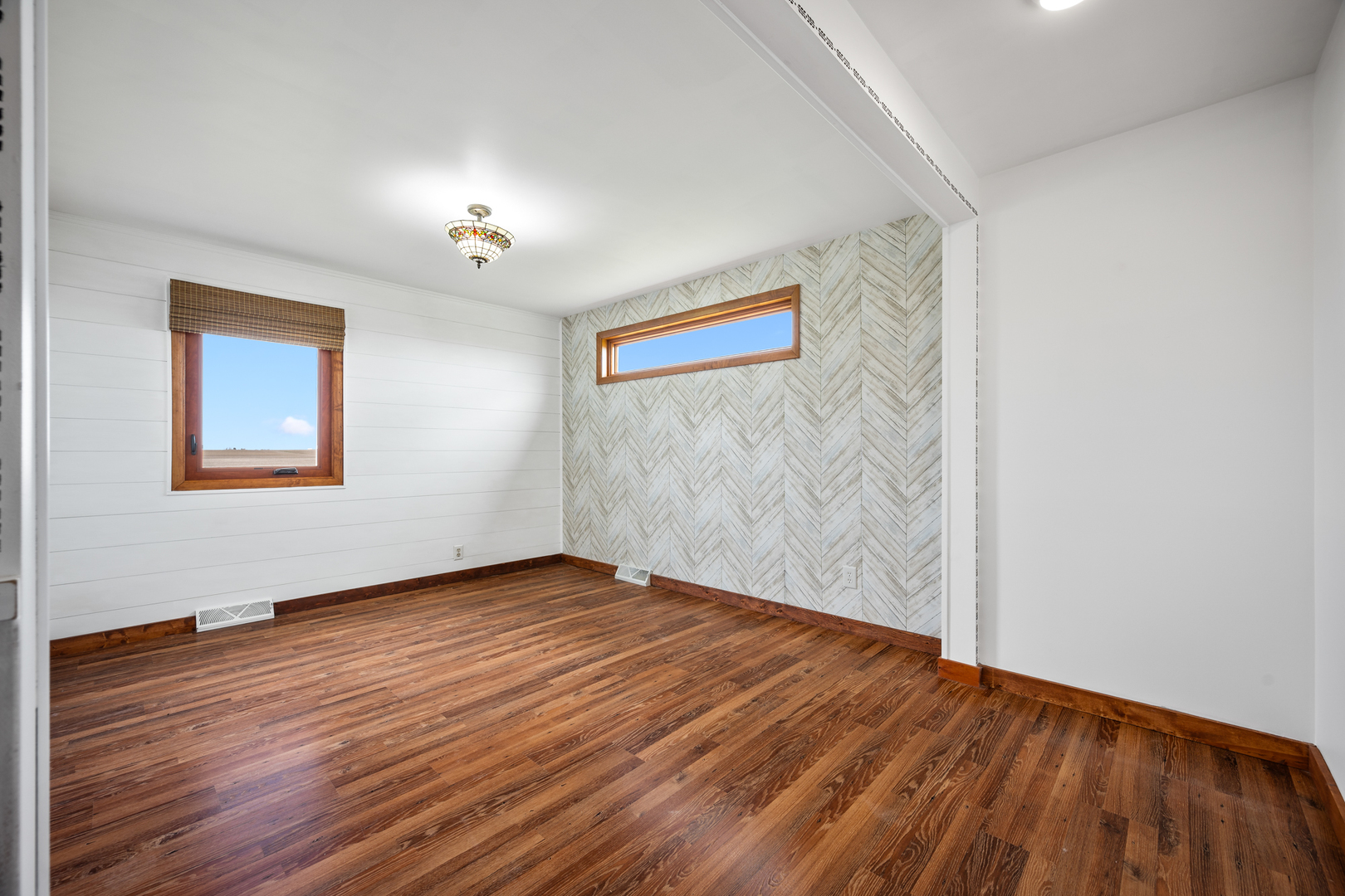 1540 East 950th Road Tonica, IL 61364 - Photo 5 of 38 a view of an empty room with wooden floor and a window