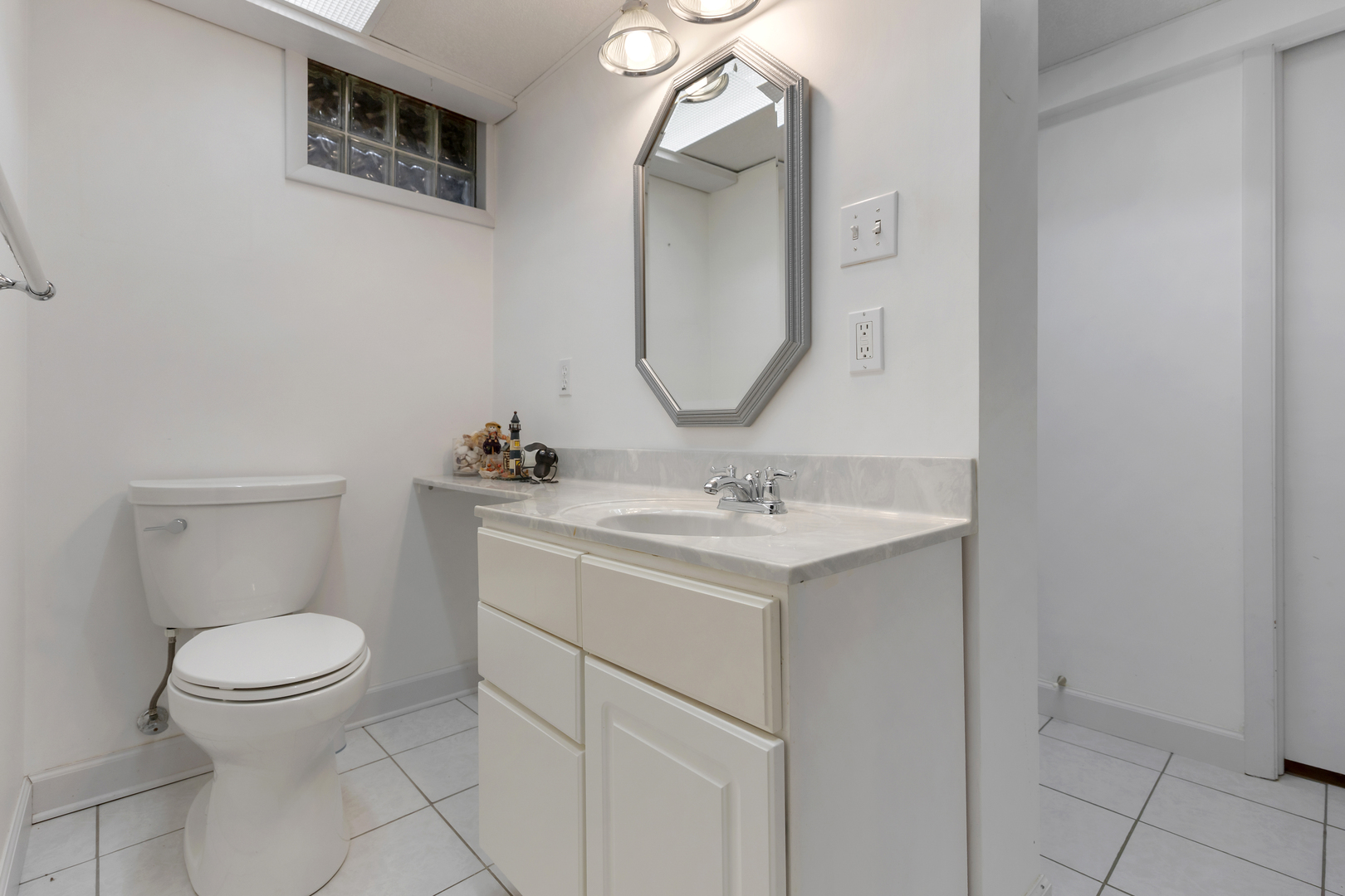 240 Scott Avenue Glen Ellyn, IL 60137 - Photo 19 of 25 a bathroom with a toilet sink and mirror