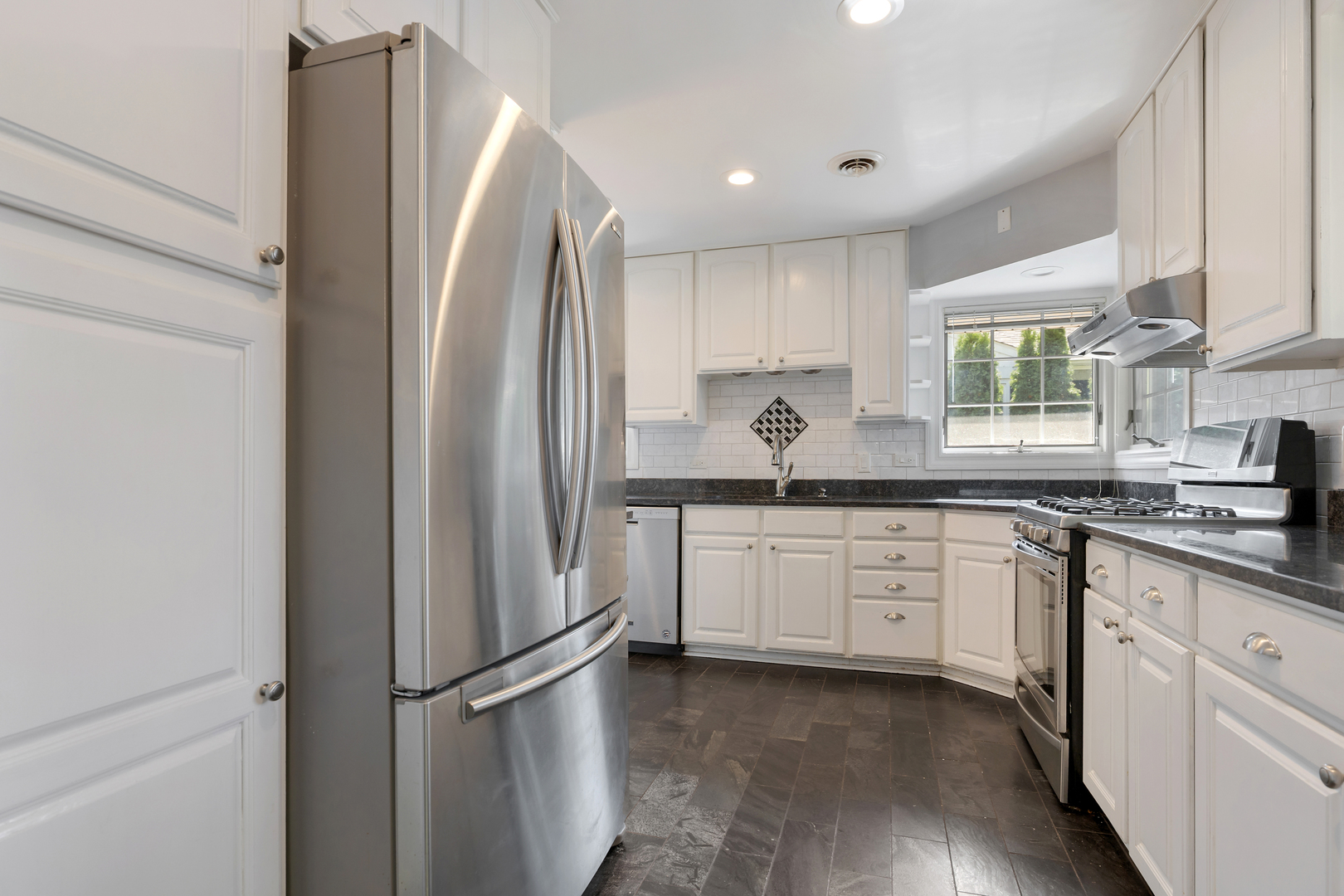 240 Scott Avenue Glen Ellyn, IL 60137 - Photo 8 of 25 a kitchen with stainless steel appliances granite countertop a refrigerator sink and white cabinets