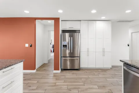 a view of a refrigerator in kitchen and wooden floor