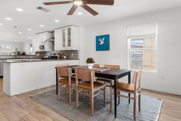 a view of a dining room with furniture and wooden floor