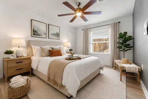 a bedroom with a bed and window