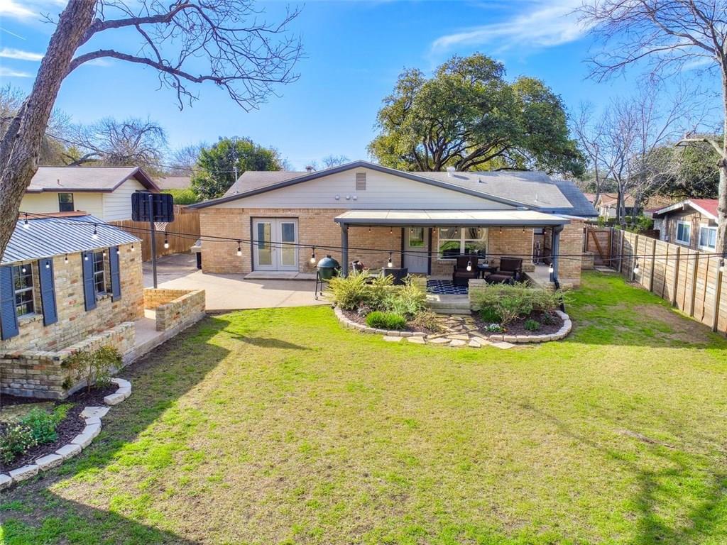 1900 Ohlen Road Austin, TX 78757 - Photo 26 of 34 Rear view of house featuring a patio area, a fenced backyard, and brick siding
