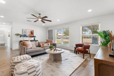 a living room with furniture potted plant and window