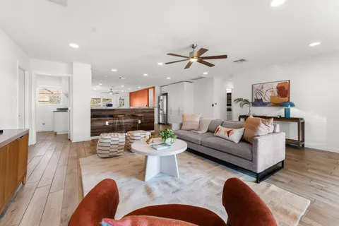 a living room with furniture kitchen view and a fireplace