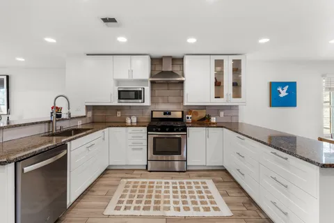 a kitchen with a sink stove and microwave