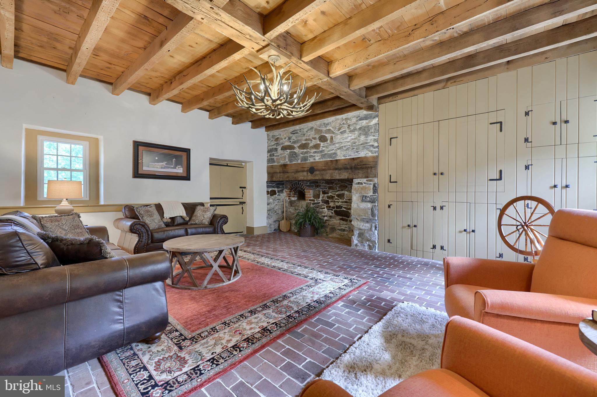 1610 Landis Road Mount Joy, PA 17552 - Photo 117 of 150 a living room with furniture a chandelier and a fireplace