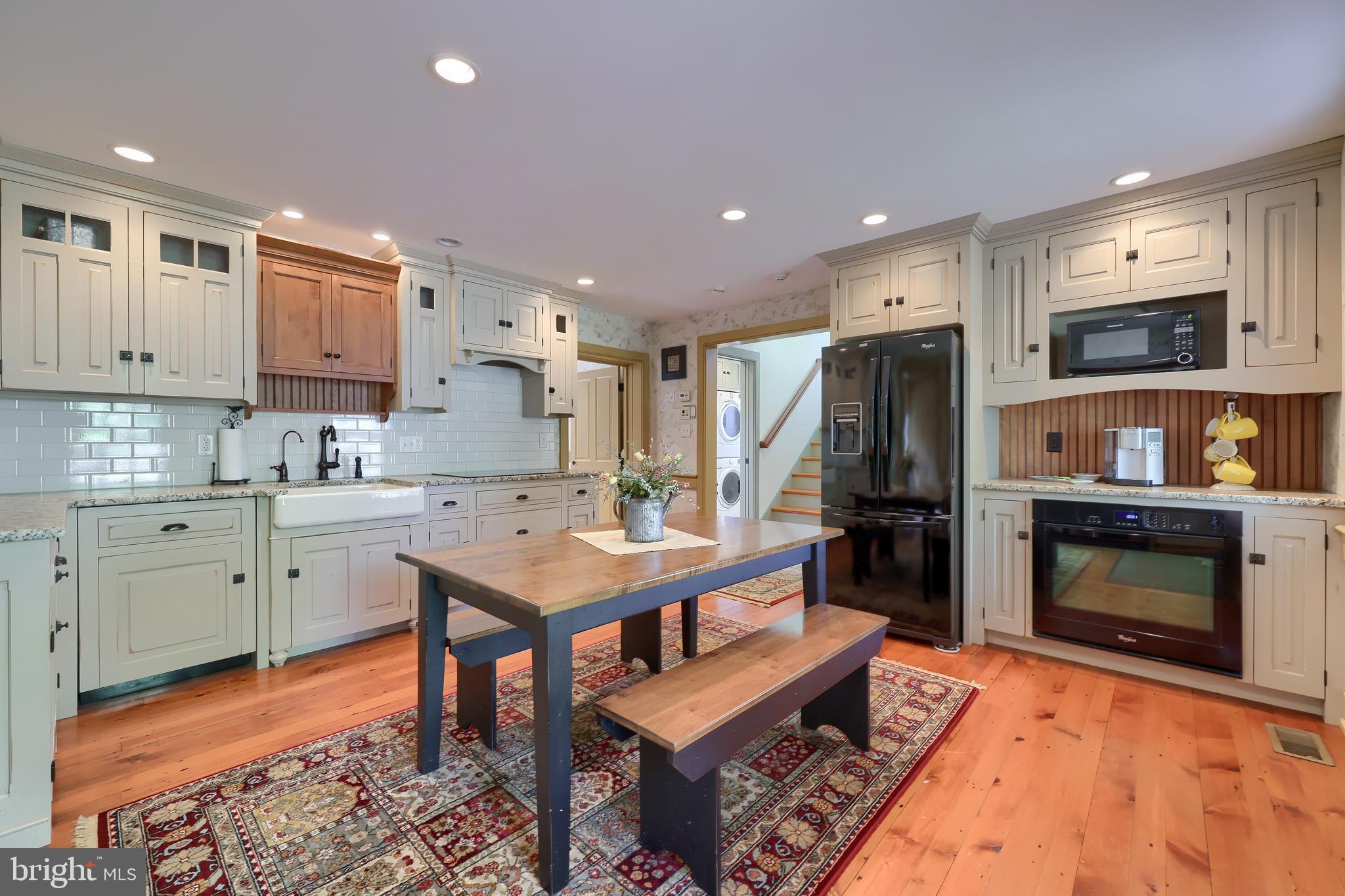 1610 Landis Road Mount Joy, PA 17552 - Photo 119 of 150 a kitchen with a refrigerator a stove top oven a sink dishwasher and white cabinets with wooden floor