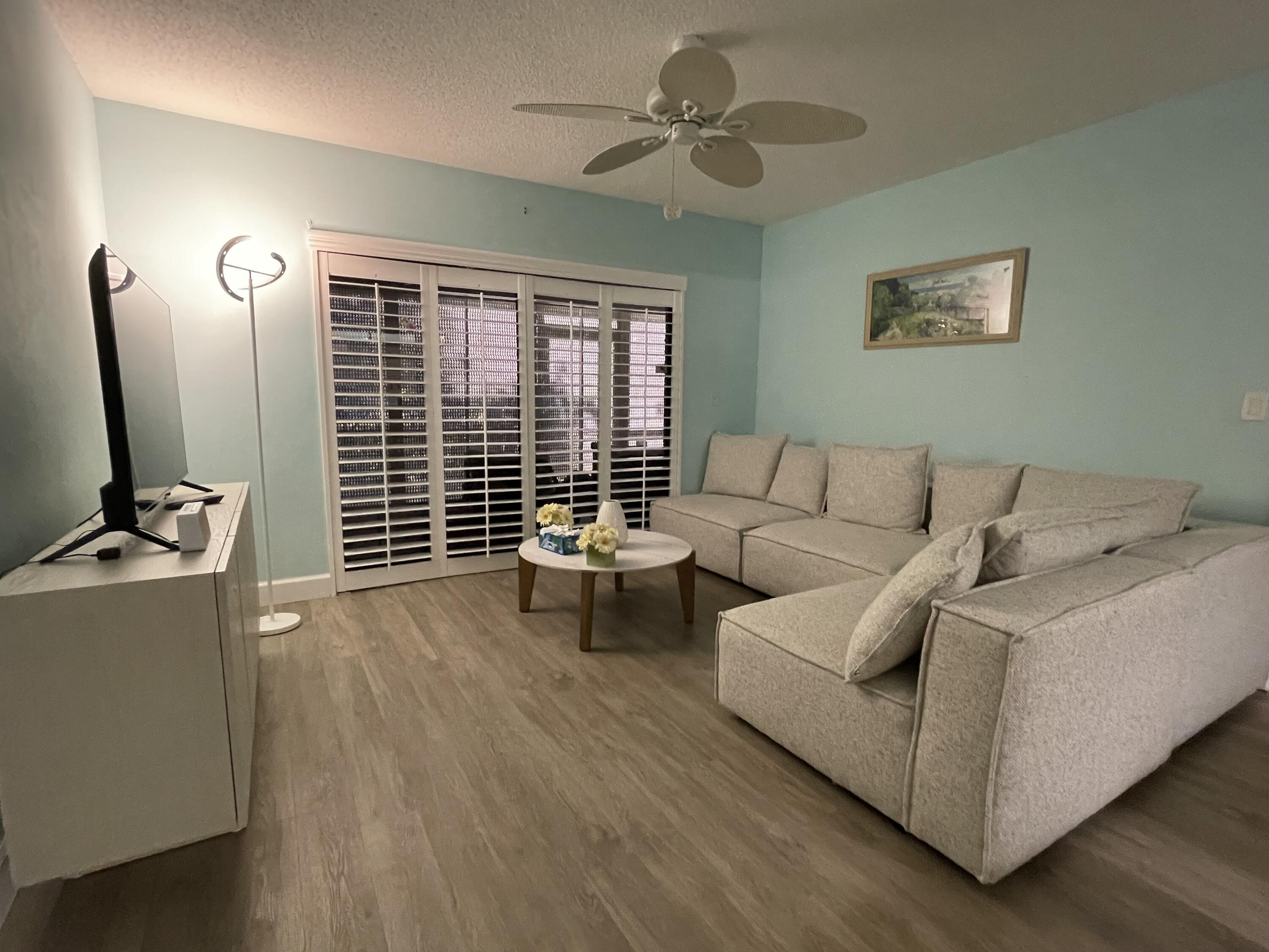 1210 Southeast Parkview Place, Unit 3 Stuart, FL 34994 - Photo 11 of 19 a living room with furniture and a flat screen tv