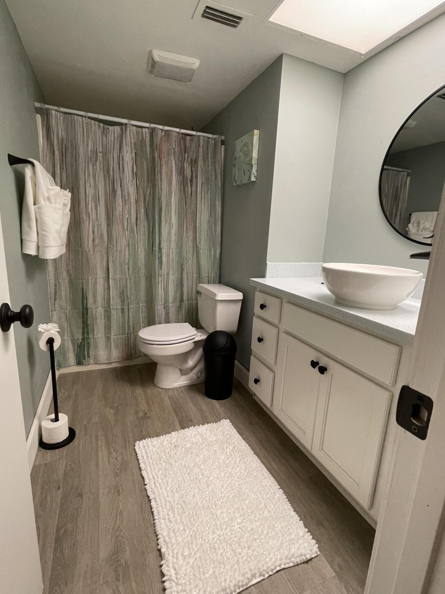 1210 Southeast Parkview Place, Unit 3 Stuart, FL 34994 - Photo 16 of 19 a bathroom with a toilet sink and mirror