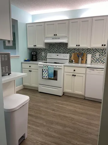 a kitchen with a stove a sink and a refrigerator