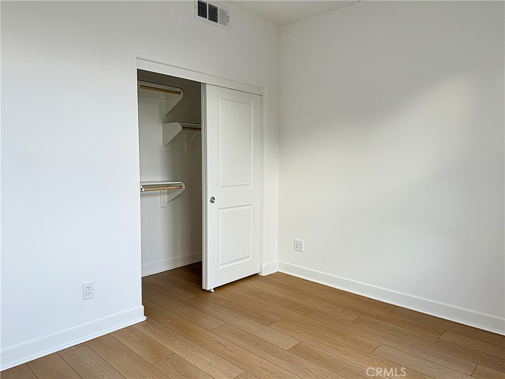 1643 Rosewell Road West Covina, CA 91791 - Photo 12 of 27 an empty room with wooden floor and closet