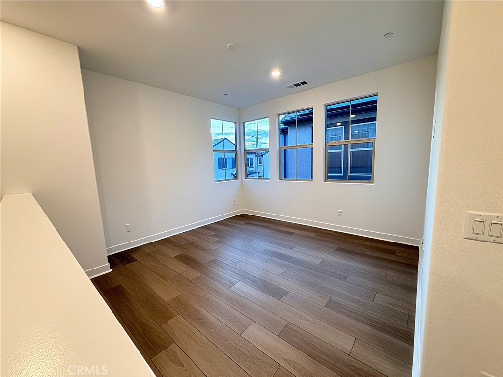 1643 Rosewell Road West Covina, CA 91791 - Photo 14 of 27 an empty room with wooden floor and windows