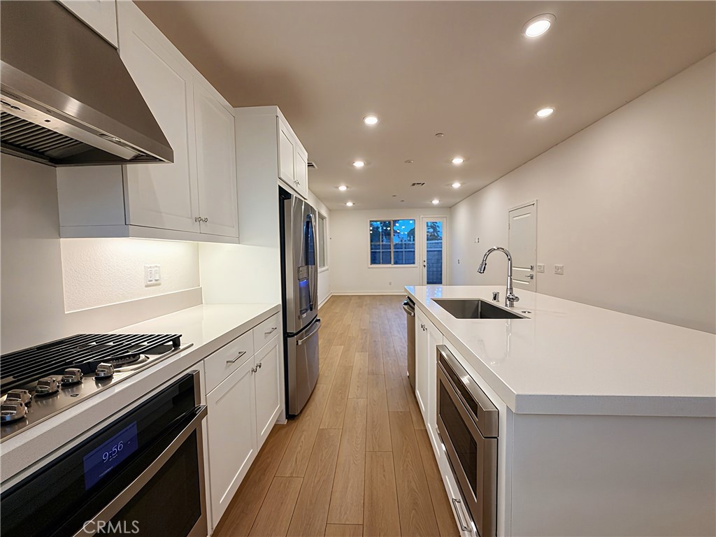 1643 Rosewell Road West Covina, CA 91791 - Photo 6 of 27 a kitchen with stove and white cabinets