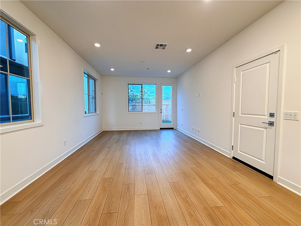 1643 Rosewell Road West Covina, CA 91791 - Photo 9 of 27 a view of an empty room with wooden floor and a window