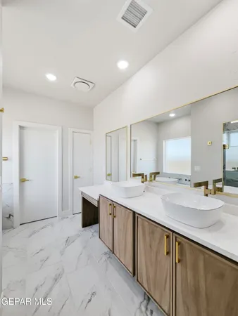 a bathroom with a sink double vanity and a mirror