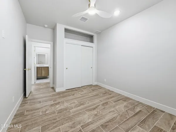a view of empty room with wooden floor