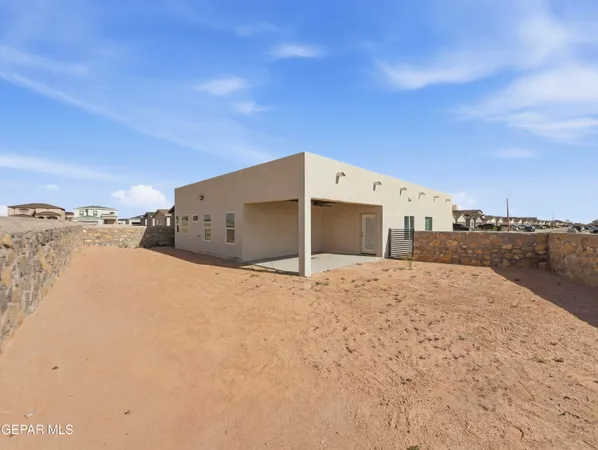 a large kitchen with a stove a sink dishwasher a refrigerator and white cabinets with wooden floor