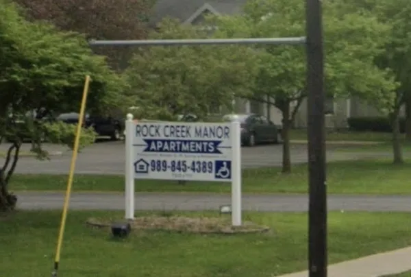 a sign on the side of a yard