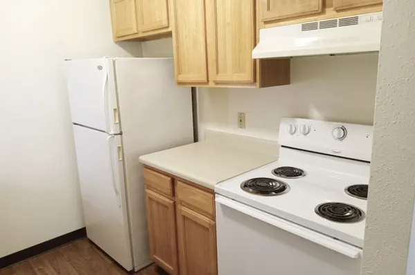 a white refrigerator freezer sitting inside of a kitchen