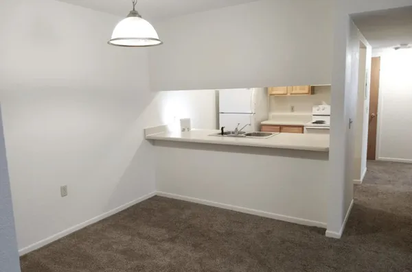 a room with a sink cabinets and a window