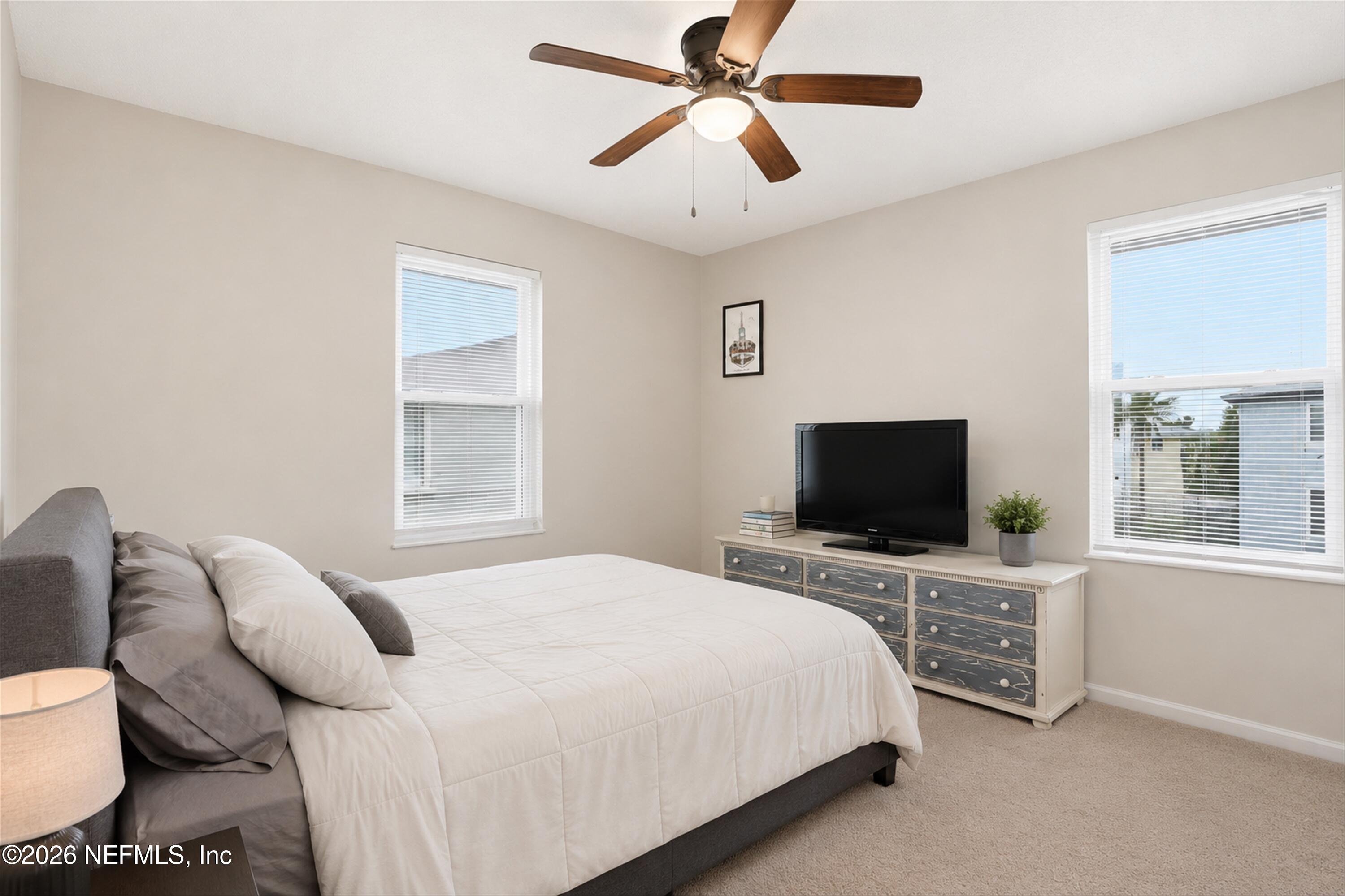124 Hopkins Street Neptune Beach, FL 32266 - Photo 13 of 44 a bedroom with a bed and a flat screen tv