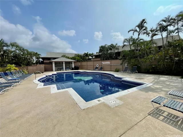 a view of a house with swimming pool yard and a patio