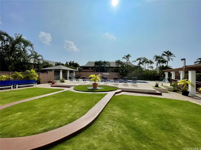a living room with furniture a rug and a wall painting